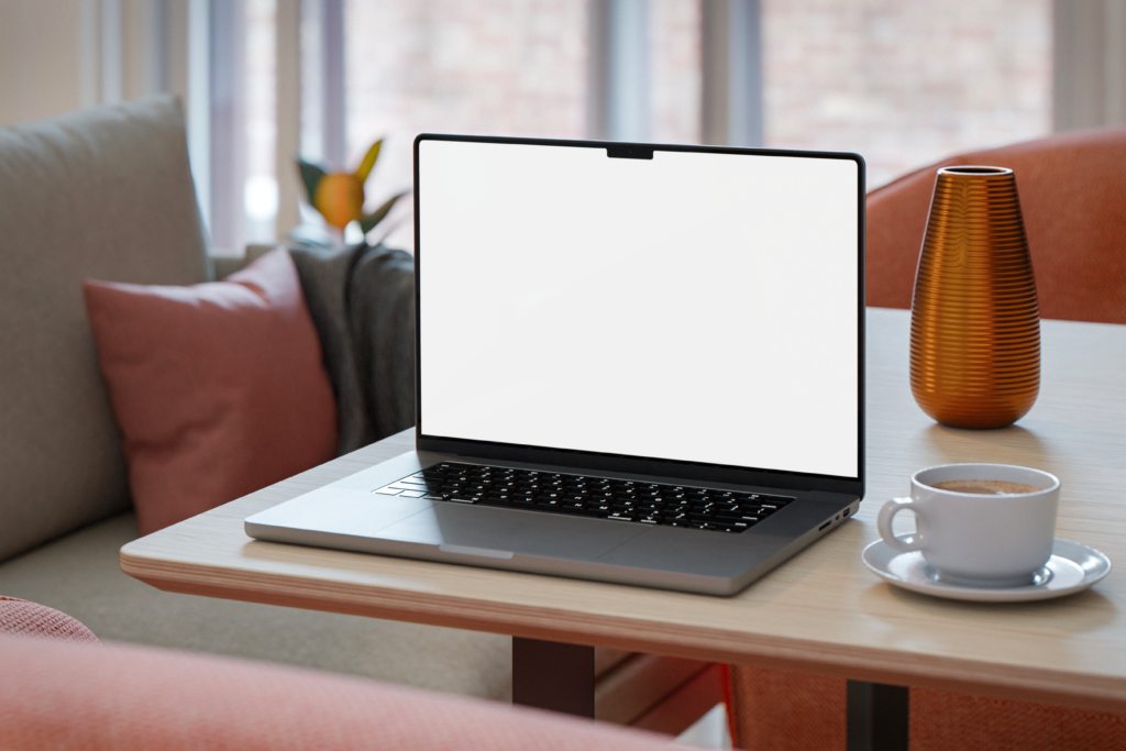 I Tested 22 Laptops Rendering with V-Ray 6. These 7 Are The Fastest For SketchUp Cozy workspace with blank laptop screen and coffee on a table.